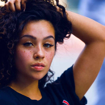 This young woman in her early 20s is concerned about acne and is wondering if vegan skincare solution would be good for her.